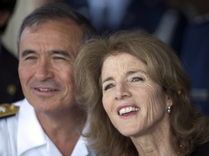 US Adm. Harry Harris,  United States Pacific Command, left, and US Amb. to Japan, Caroline Kennedy, watch Japanese Prime Minster Shinzo Abe arrive at Joint Base Pearl Harbor Hickam, Monday, Dec. 26, 2016, in Honolulu.  Abe will visit Pearl Harbor with U.S. President Barack Obama Tuesday, becoming the first leader of Japan to visit Pearl Harbor, the site of the surprise attack that propelled the United States into World War II.  This year marks the 75th anniversary of the Japanese attack.  (AP Photo/Marco Garcia)