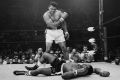Heavyweight champion Muhammad Ali stands over fallen challenger Sonny Liston.
