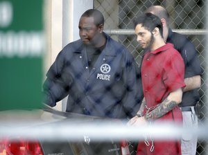 Esteban Santiago leaves the Broward County jail for a hearing in federal court, Tuesday, Jan. 17, 2017, in Fort Lauderdale, Fla.