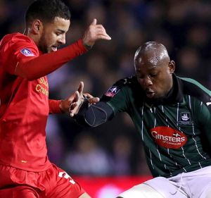 Plymouth Argyle's Paul Arnold Garita and Liverpool's Kevin Stewart battle for the ball.