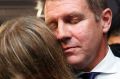 Premier Mike Baird hugs his daughter after a press conference announcing his resignation in Sydney. 