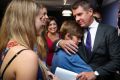 Mike Baird embraces his family after the emotional  press conference where he announced his resignation.