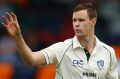 Jason Behrendorff of the Prime Minister's XI prepares to bowl with the pink ball during the tour match against New Zealand.