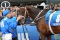 She's back: Hugh Bowman gives Winx a pat after her second Cox Plate victory.