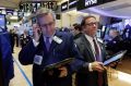 Traders Christopher Fuchs, left, and Sal Suarino work on the floor of the New York Stock Exchange, Tuesday, Jan. 17, ...