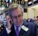 Traders Christopher Fuchs, left, and Sal Suarino work on the floor of the New York Stock Exchange, Tuesday, Jan. 17, ...