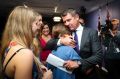 Premier Mike Baird embraces his family after a press conference annpuoncing his resignation in Sydney. 