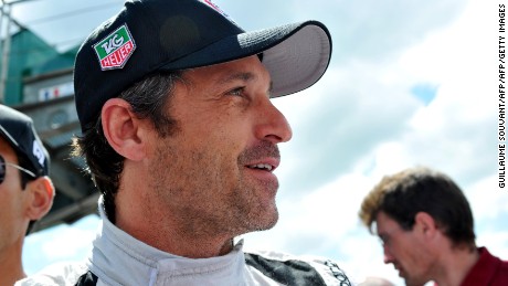 US Actor Patrick Dempsey who drives the Porsche 911 RSR N? 77 smiles in the pit before the start of the 82nd Le Mans 24 hours endurance race, on June 14, 2014 in Le Mans, western France. Fifty-six cars with 168 drivers are participating on June 14 and 15 in the Le Mans 24-hours endurance race. AFP PHOTO / GUILLAUME SOUVANT        (Photo credit should read GUILLAUME SOUVANT/AFP/Getty Images)