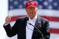 Donald Trump on the campaign trail in one of the signature baseball caps. 