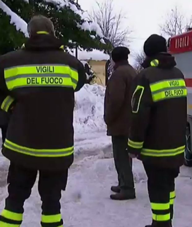 Rescuers wait next to a fire truck in Abruzzo on Thursday morning.