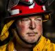 Bungendore RFS Captain, Sheldon Williams, in burnt land near Hazeldell Rd where he worked to save properties in January ...