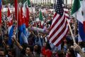 Demonstrators hold signs and flags during a protest against US President-elect Donald Trump outside of the Federal ...