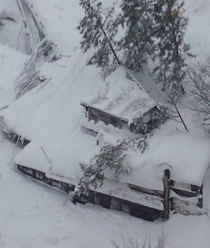 An aerial view shows the hotel Rigopiano buried by snow.