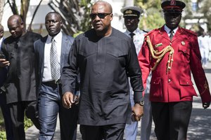 Ghana President, John Dramani Mahama, walks on arrival for talks with President Yahya Jammeh, in Banjul, Gambia