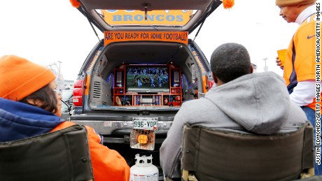 DENVER, CO - JANUARY 11: Denver Broncos fans watch football on a TV in the back of their car as they have a tail gate party outside of the venue before a 2015 AFC Divisional Playoff game between the Denver Broncos and the Indianapolis Colts at Sports Authority Field at Mile High on January 11, 2015 in Denver, Colorado.  (Photo by Justin Edmonds/Getty Images)