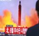 A man watches a TV news program showing a file image of a missile launch conducted by North Korea, at the Seoul Railway ...