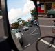 In view: a cyclist passes a parked car.