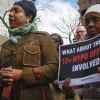 Constance Malcolm, left, mother of Ramarley Graham, speaks as mother Patricia Hartley, right, holds a sign during a press conference outside police headquarters, Thursday Jan. 19, 2017, in New York. A disciplinary trial is underway for NYPD officer Richard Haste, who shot and killed the unarmed 18-year-old Graham in the bathroom of his New York City apartment. (AP Photo/Bebeto Matthews)