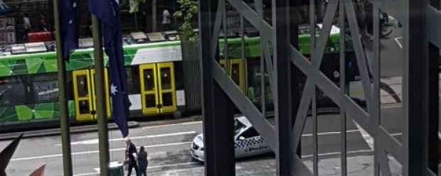 Police treating a person in Melbourne's CBD.