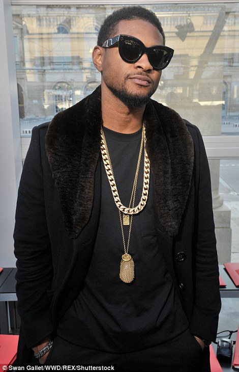 Dapper: Usher layered up with a black coat and donned gold chains