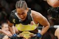 Amanda Nunes celebrates after winning the UFC's  women's bantamweight championship.