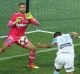 Tim Cahill heads the ball past Mariners goalkeeper Paul Izzo.