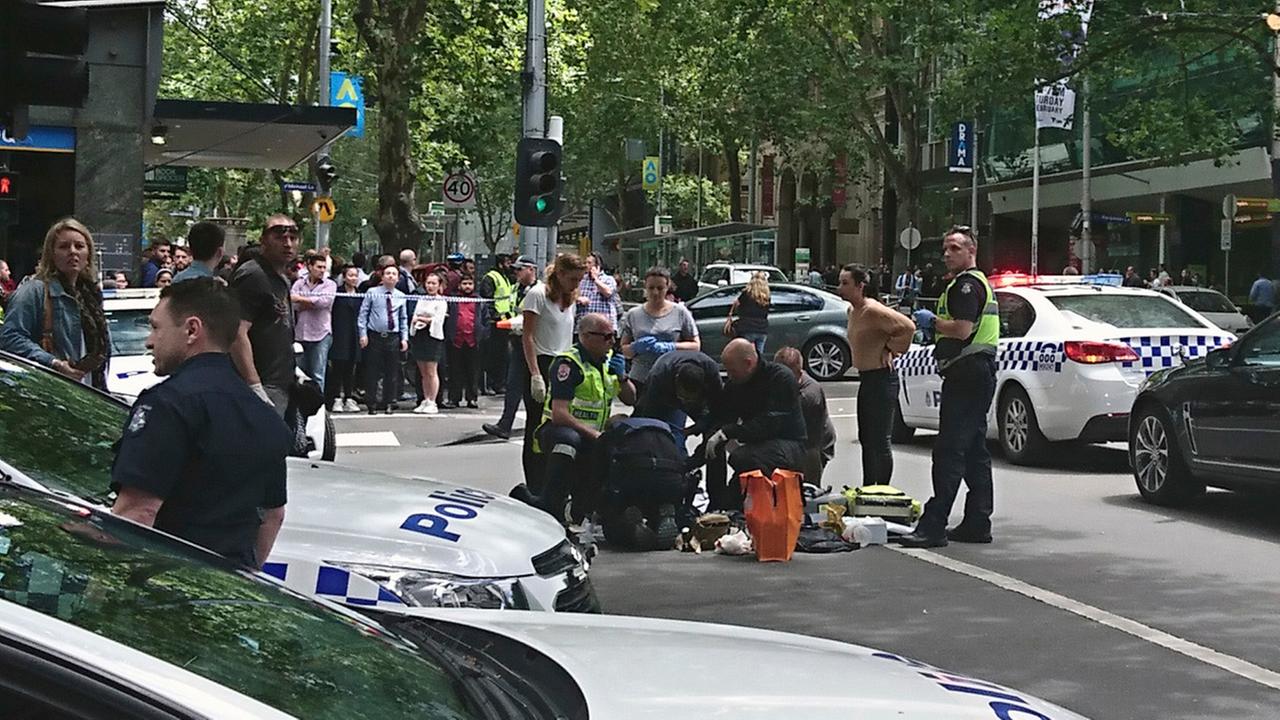 Police and emergency services gather at the scene after a car is believed to have hit pedestrians in Bourke Street Mall in Melbourne, Australia, Friday, Jan. 20, 2017.