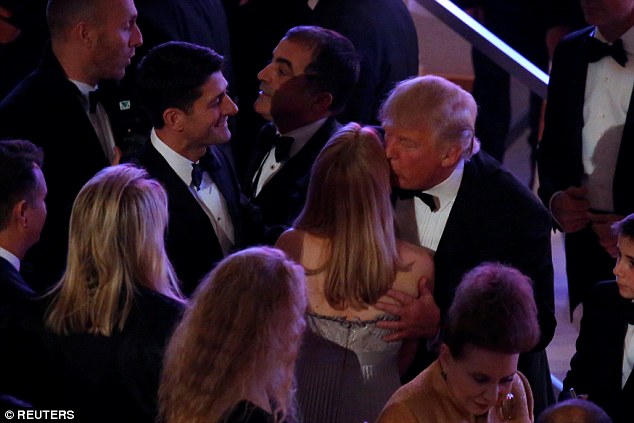 President-elect Donald Trump (R) greets U.S. House Speaker Paul Ryan (R-WI) (L) and other guests at a pre-inauguration candlelight dinner