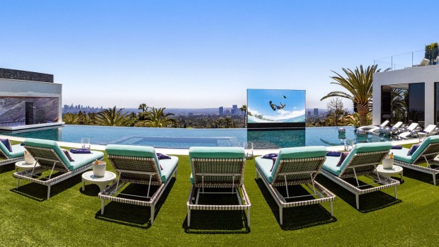 A pop-up television screen and a swim-up bar accompany the 85-foot-long infinity-edge swimming pool.