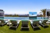 A pop-up television screen and a swim-up bar accompany the 85-foot-long infinity-edge swimming pool.