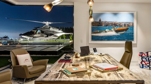 The penthouse study looks out over the private helipad and helicopter.