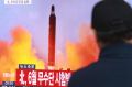 A man watches a TV news program showing a file image of a missile launch conducted by North Korea, at the Seoul Railway ...