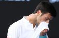 MELBOURNE, AUSTRALIA - JANUARY 19: Novak Djokovic of Serbia reacts in his second round match against Denis Istomin of ...