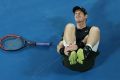 Andy Murray holds his ankle.