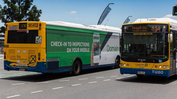 Give way signs are plastered on the back of Brisbane's buses. 