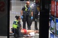 Police with a man who is believed to be the driver of a car that has hit pedestrians in Bourke Street Mall in Melbourne