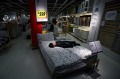 A customer rests on a bed inside the Ikea Beijing Xihongmen Store, operated by Ikea in Beijing, China.