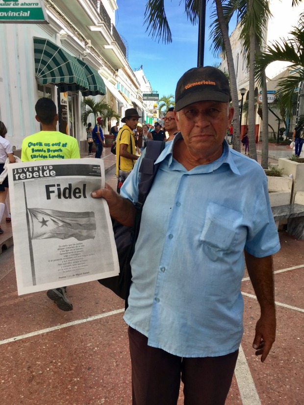 A man selling newspapers in Cienfuegos, days after Castro's death.