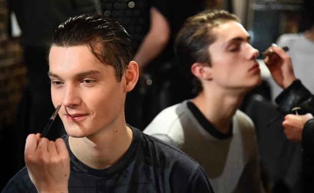 Models backstage at London Men's Fashion Week on January 6.  Metrosexual purchasing power is giving menswear a huge boost.