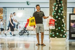 Dom Fusca taking the second load of shopping to the car as his wife shopped. 