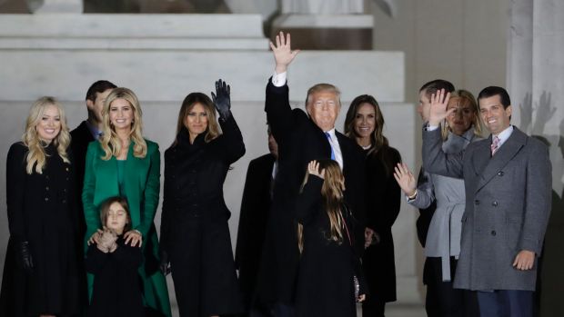 President-elect Donald Trump, his wife Melania Trump and family wave at the conclusion of the pre-Inaugural "Make ...