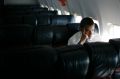 Democratic presidential hopeful Sen. Barack Obama, D-Ill., reads a newspaper on his campaign charter en route to ...