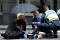 A person receives treatment in the aftermath of the Bourke Street incident