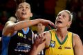 Canberra centre Marianna Tolo (left) will look to keep Suzy Batkovic at bay when the Capitals host Townsville on Saturday. 
