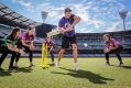 Nick Riewoldt has a hit as Gemma Triscari, Emma Inglis, Jess Cameron and Alana King field at the MCG on Friday.