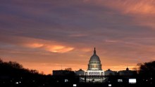 The sun rises over the US Capitol on the National Mall