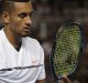 MELBOURNE, AUSTRALIA - JANUARY 17: Nick Kyrgios of Australia looks at his racquet after breaking a string during his ...
