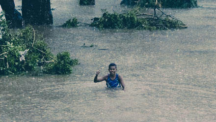 Boy holding thumb up waist height in water