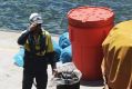 Workers on the oil spill clean-up at Viva Energy's Gore Bay site.