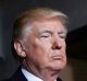 President-elect Donald Trump pauses as he waits to be introduced on the West Front of the U.S. Capitol on Friday, Jan. ...